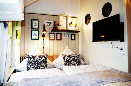 Doppelbett mit Blick zum Fernseher , der Badwand, den Bullaugen